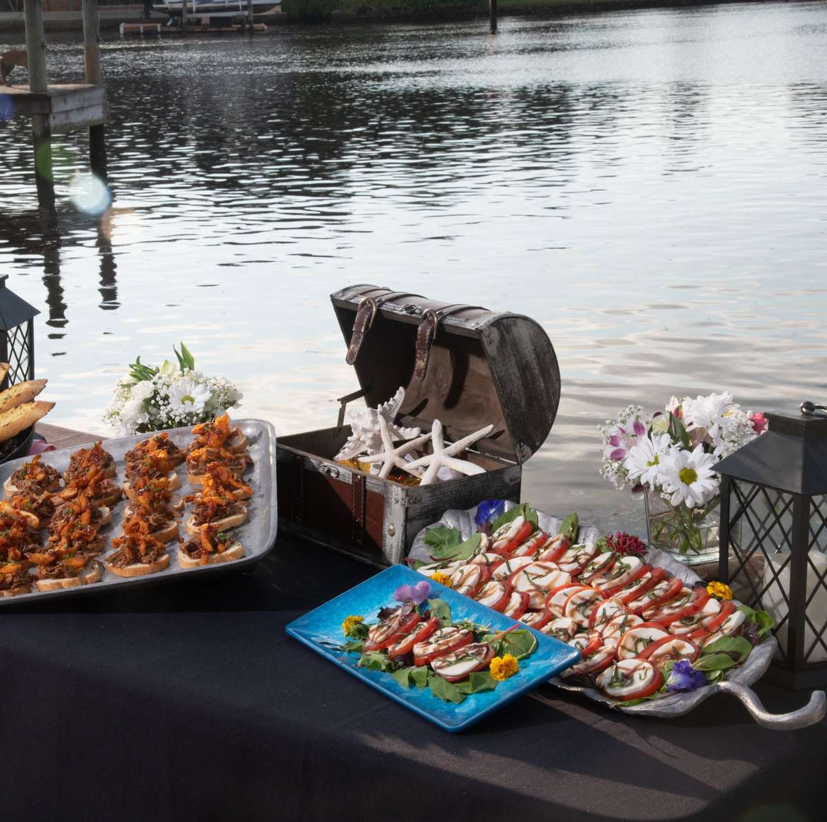 a buffet style table by the water