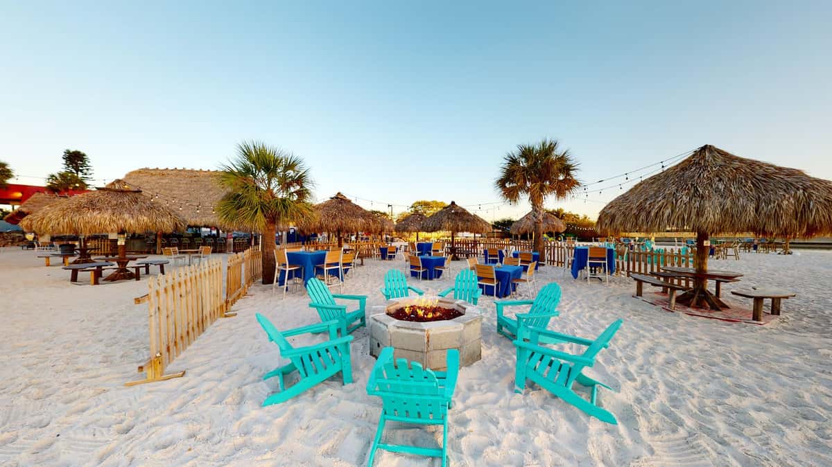 fire pit and Adirondack chairs on the beach