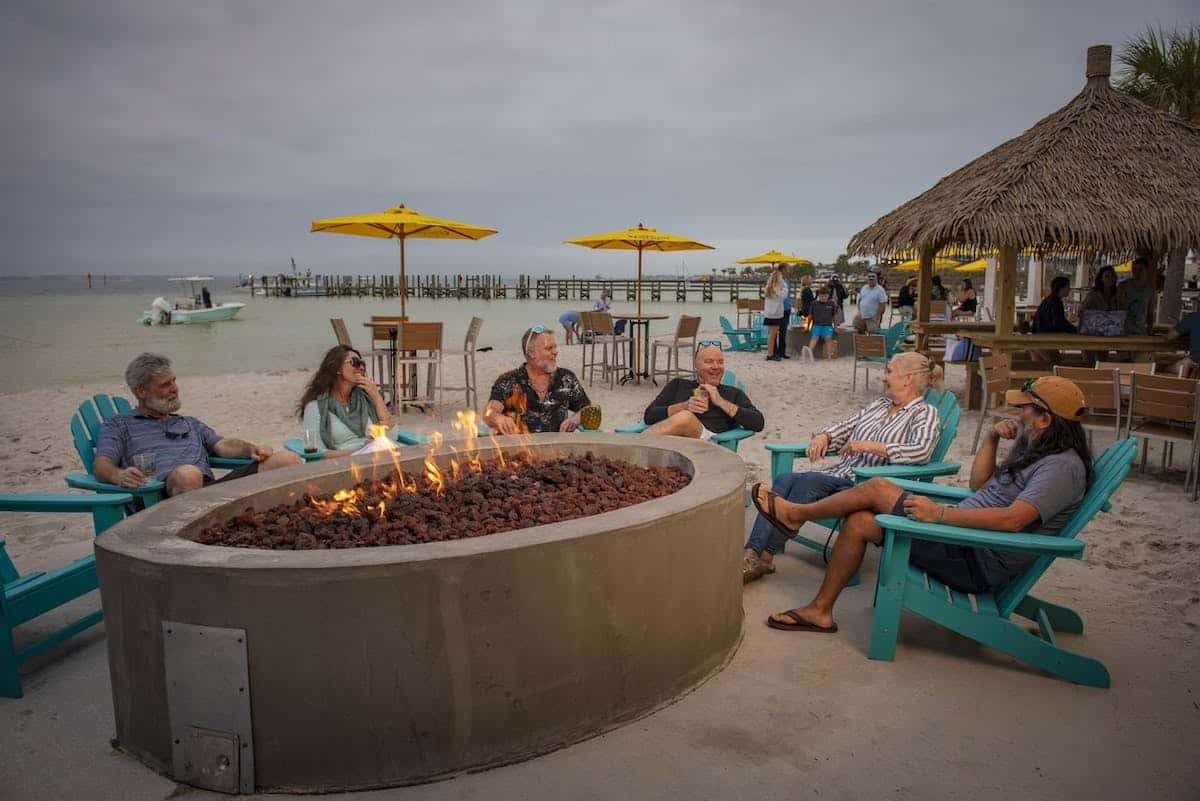 people sitting around a fire pit