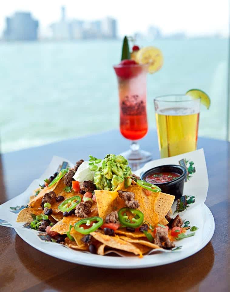 plate of nachos and two cocktails