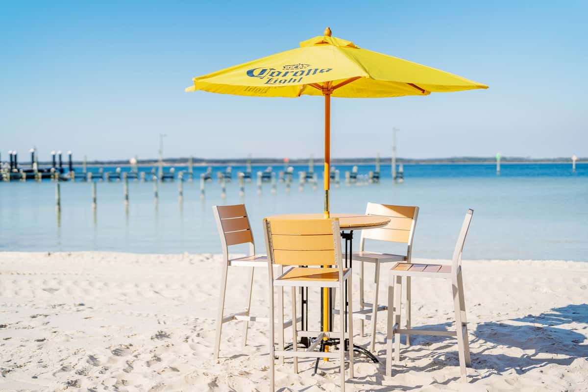 a table and umbrella on the beach