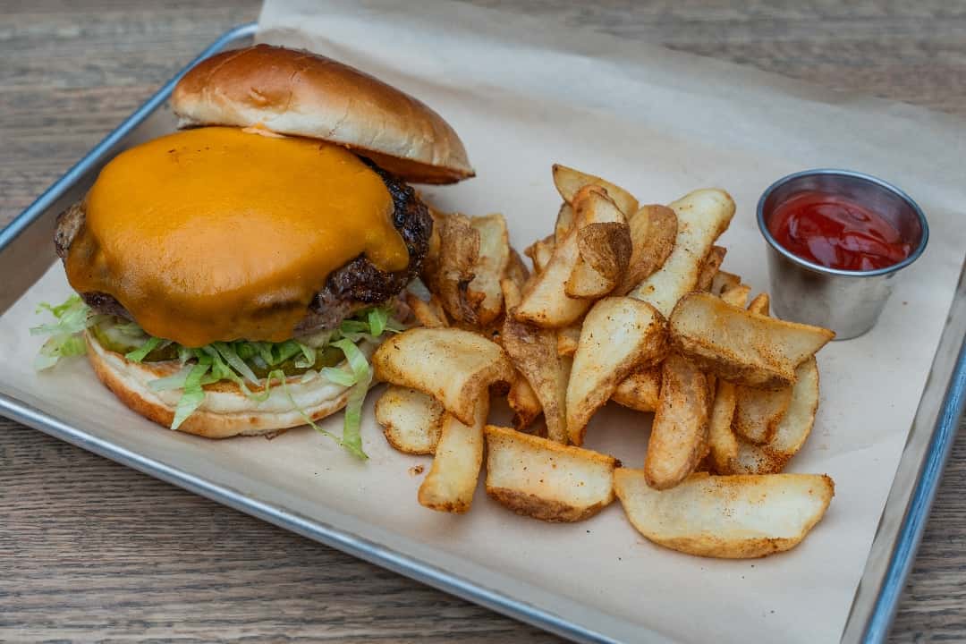 Prime Steak Burger with almost zero fat content makes for a lean bite! Topped with Baby Iceberg Lettuce, Tomato, Cheddar Cheese, Homemade Chipotle Aioli, served on Brioche