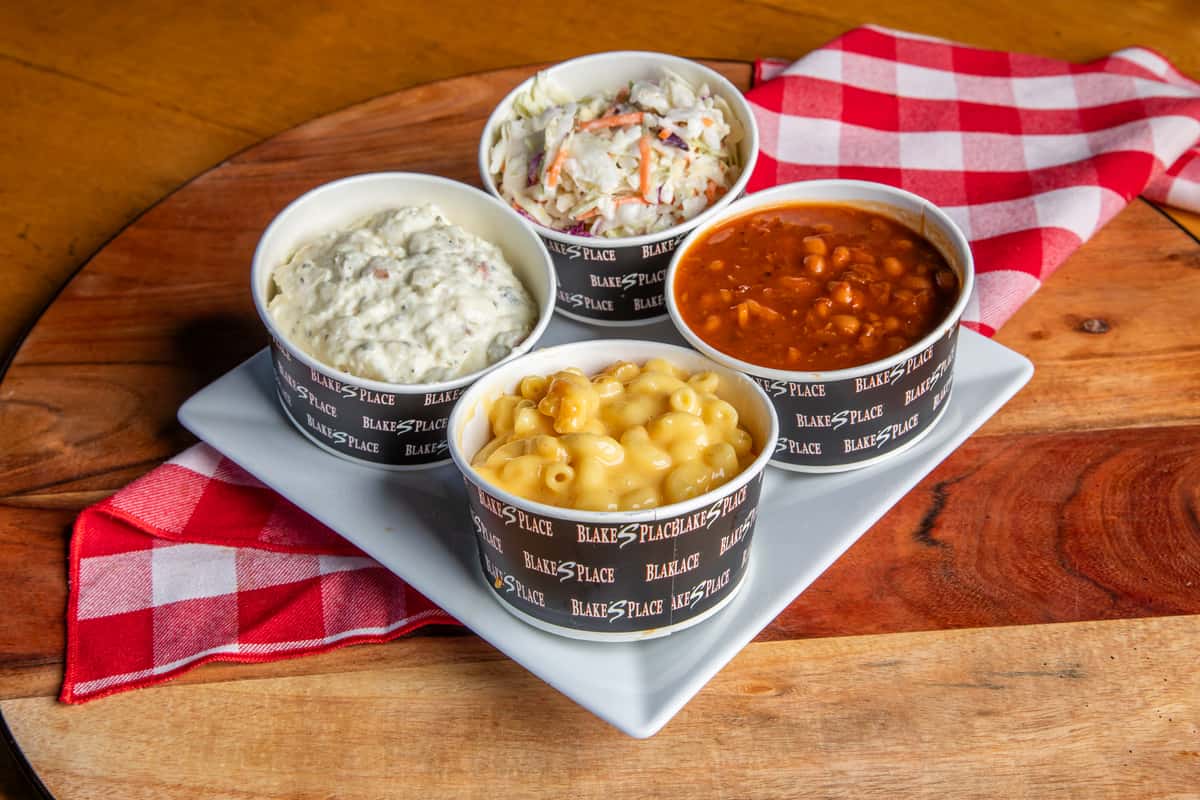 Sides of mac and cheese, coleslaw, potato salad and baked beans