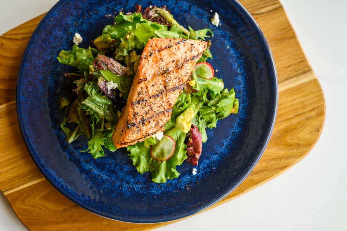 Grilled Salmon Salad on blue plate