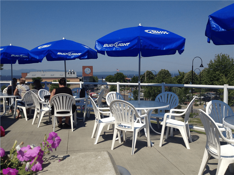 outside patio with seating under umbrellas