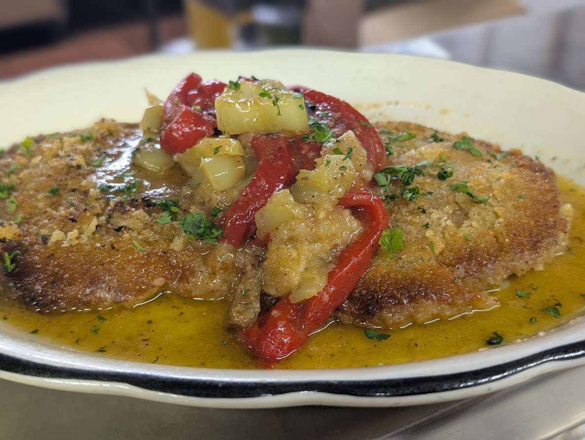 Hand Breaded Pork cutlet. Pan fried then topped with Sauteed Sweet and hot peppers. Finished a White vinegar for an explosive flavor