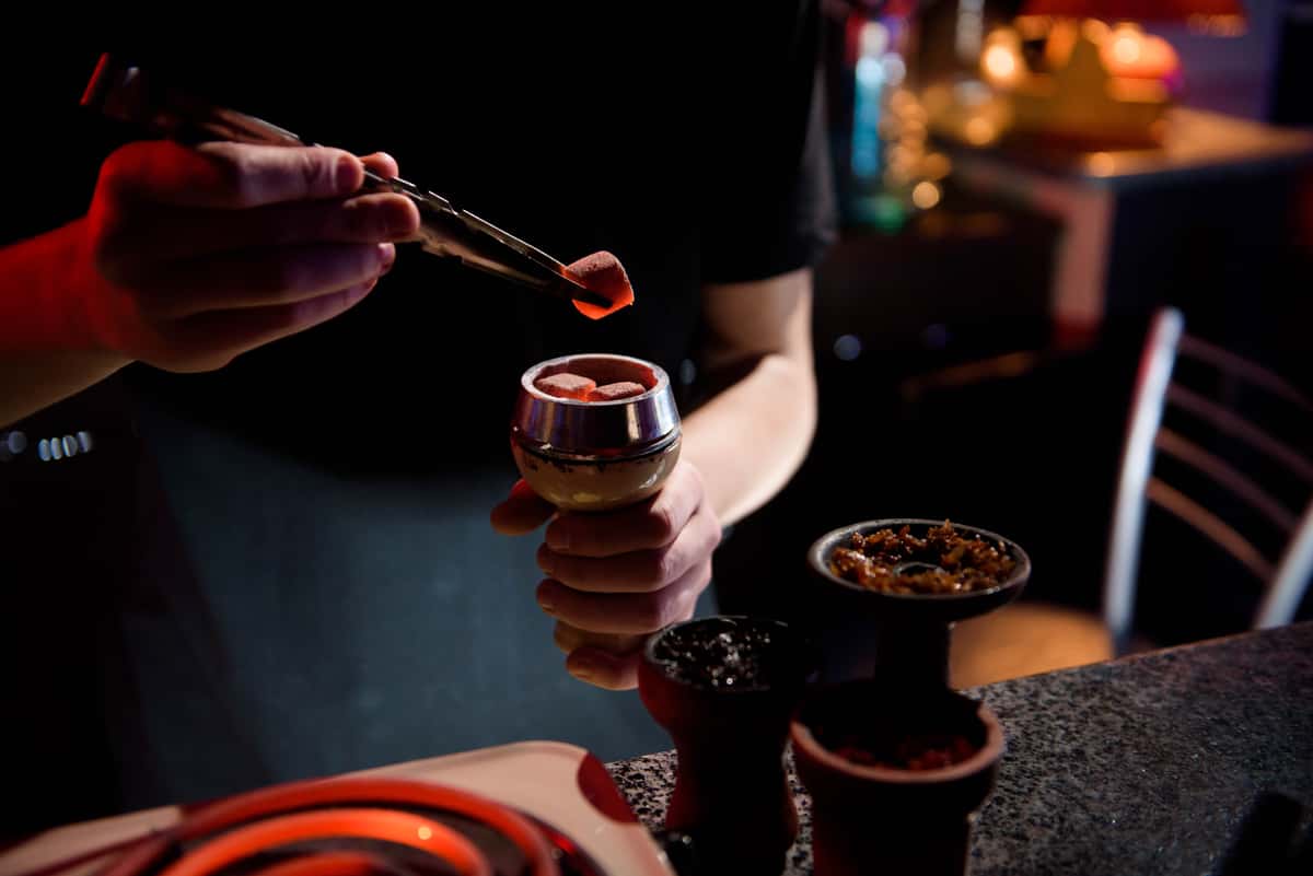 A man preparing a hookah