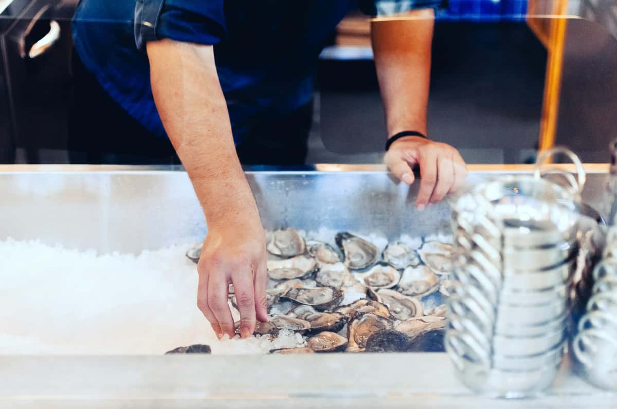 person sorting oysters