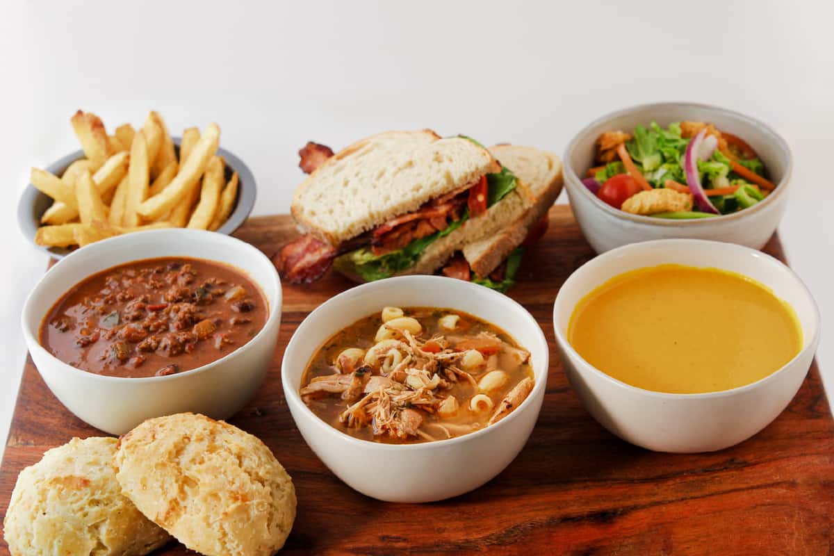 Spread of soups, sandwiches, and sides
