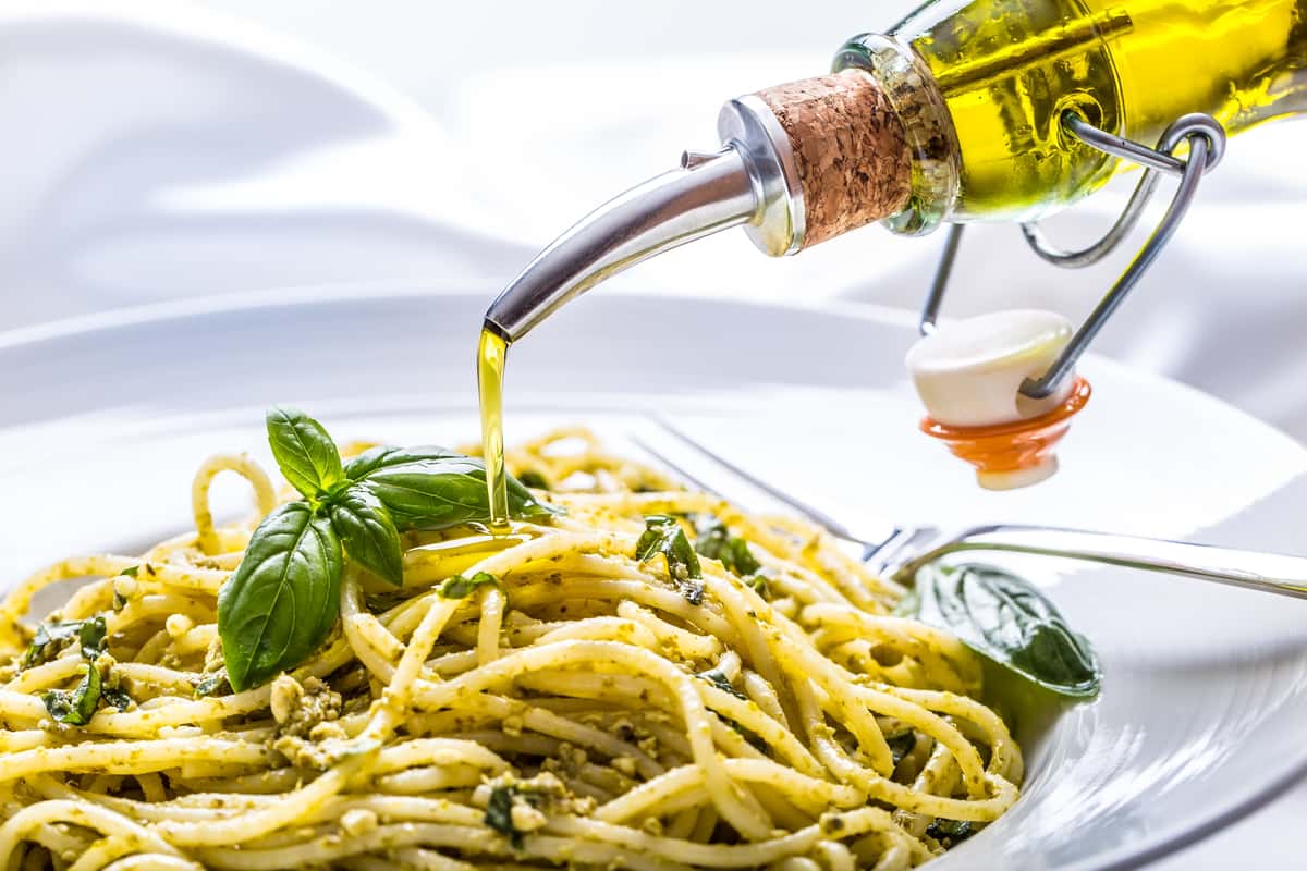 Olive oil being drizzled on fresh pasta
