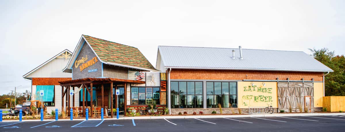 Vibrant exterior of Crooked Hammock Brewery with unique architecture and a colorful, welcoming entrance.