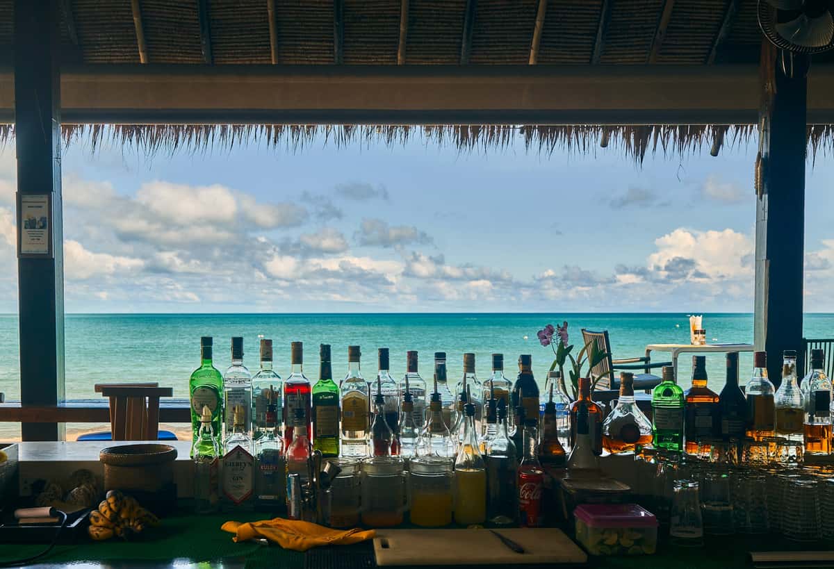 Beach bar with a spread of drinks over the ocean view