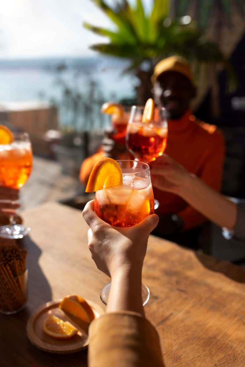 Beach cocktails with a group by a wooden table
