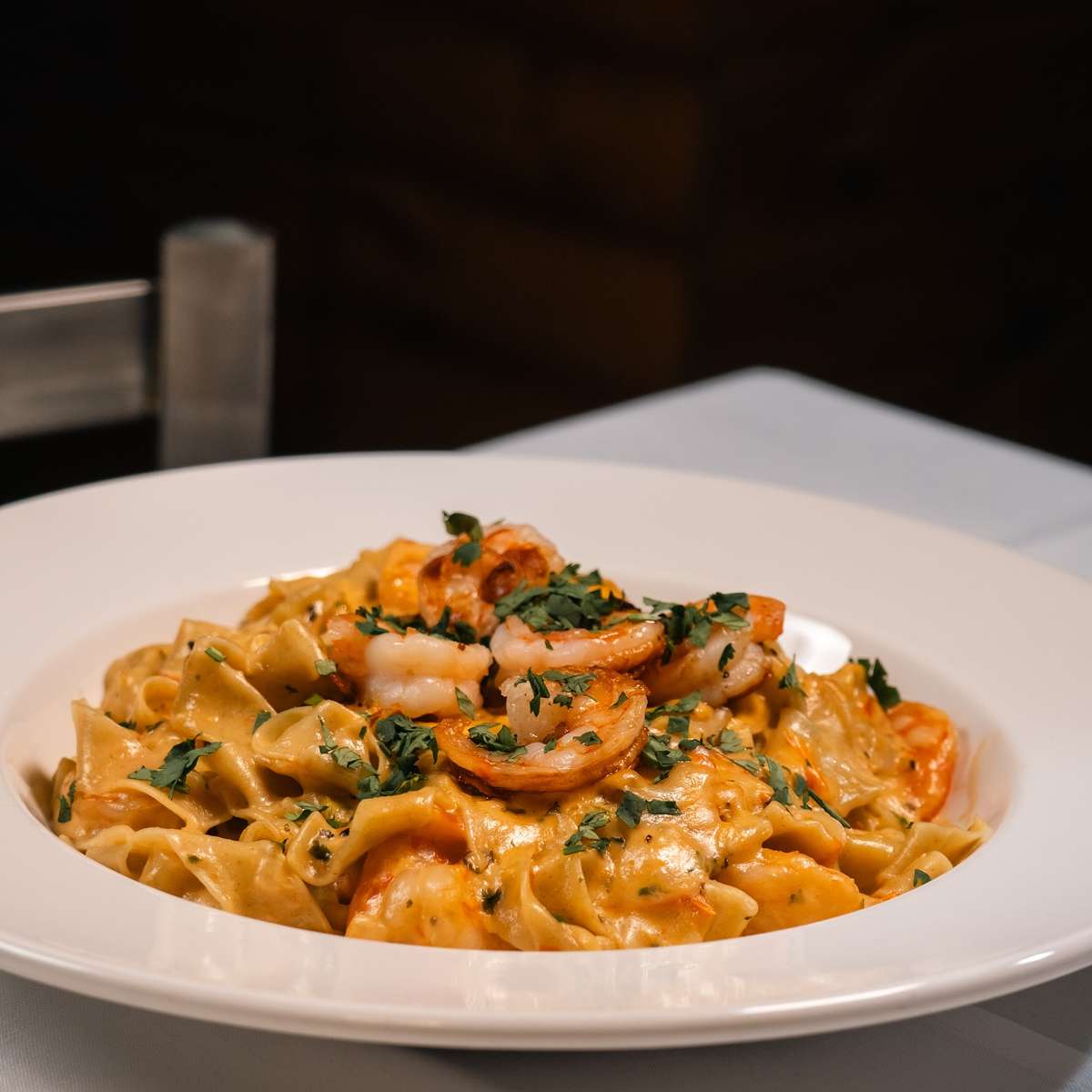 homemade pasta, perfectly al dente, coated in a rich, traditional Italian sauce and topped with succulent shrimp