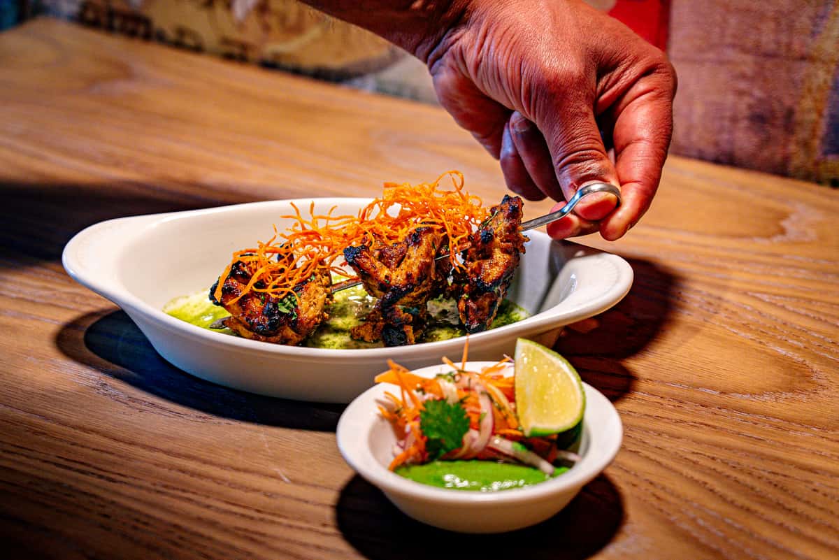 Person lifting a spoon of a meat dish