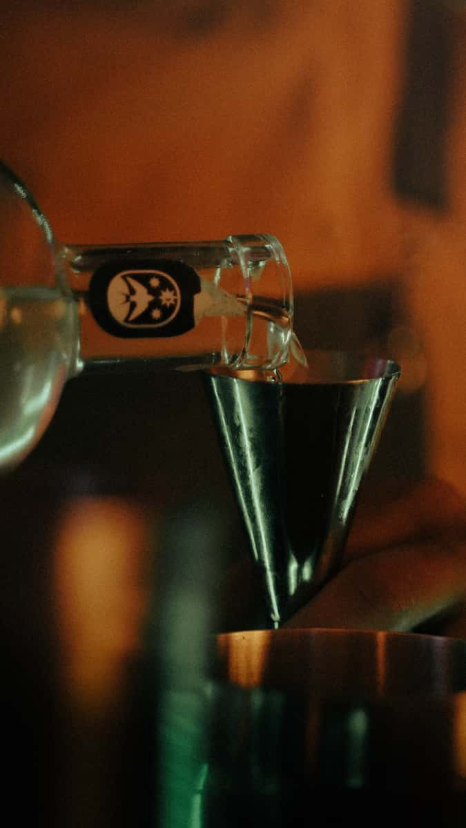 shot of tequila being poured