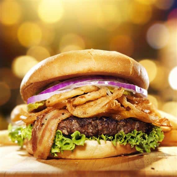 hamburger topped with lettuce, bacon, onions and onion straws