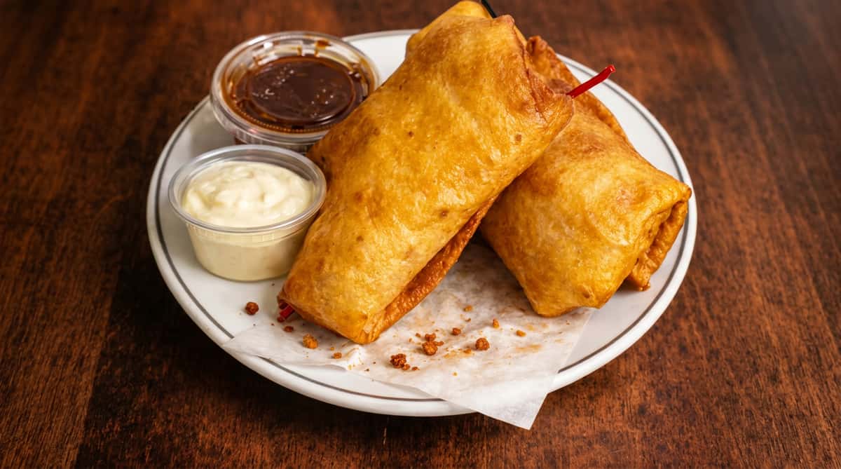 Crispy golden chimichangas with dipping sauces at DSquared in St. Louis
