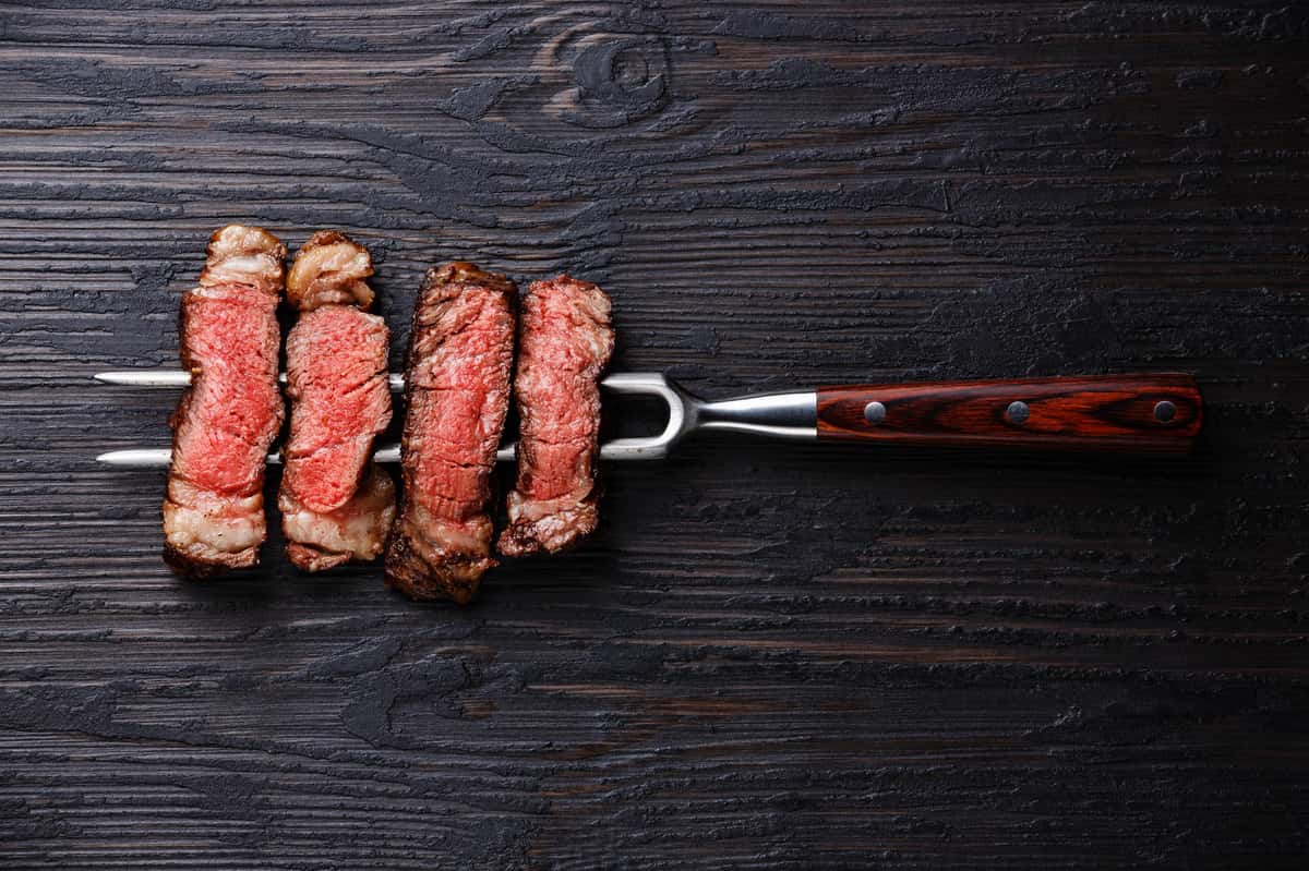 steak on grilling fork