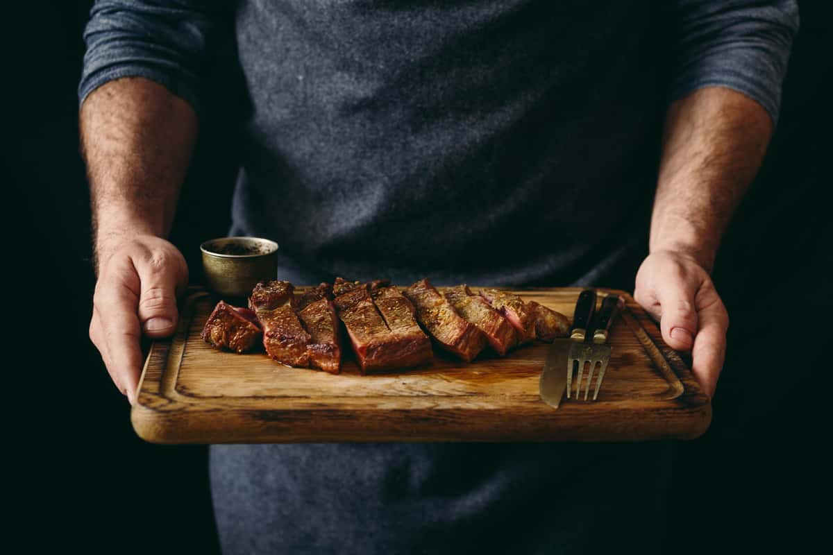 man holding steak
