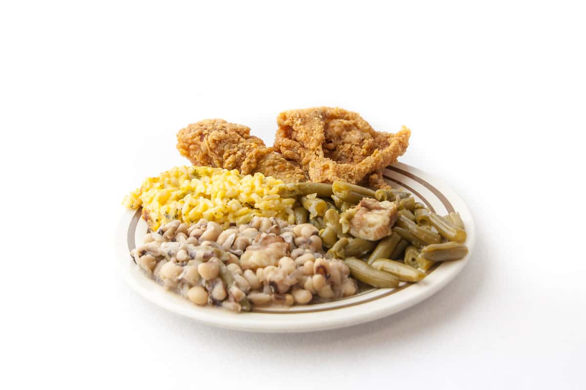 plate of fried chicken with green beans, pinto beans and mac and cheese