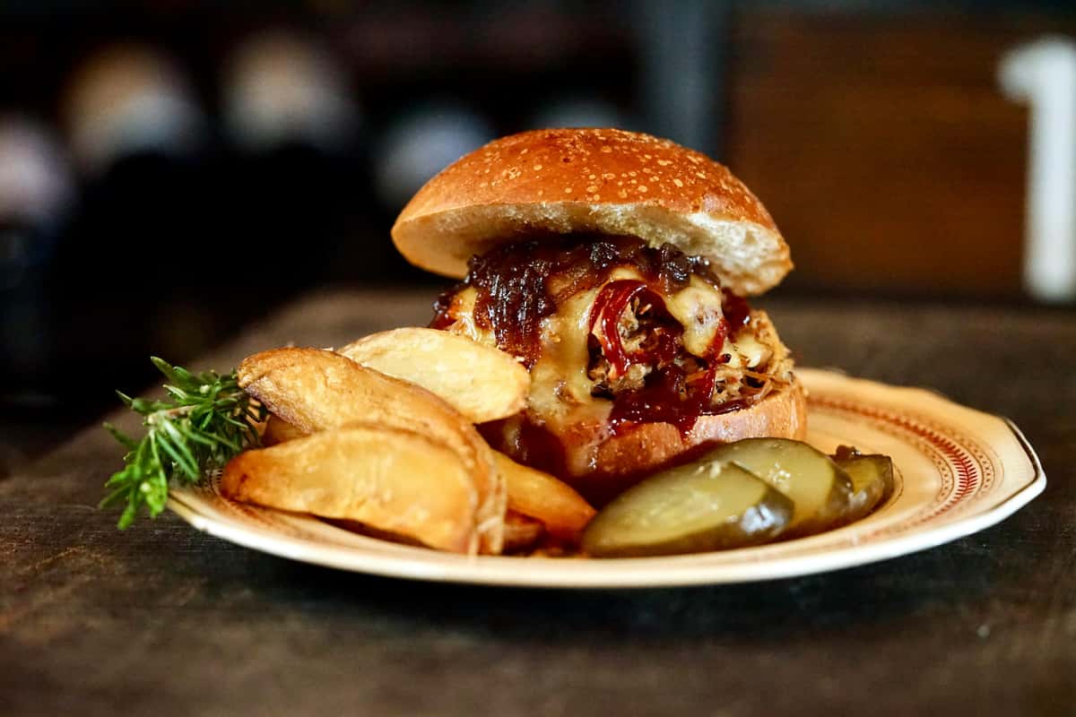 Burger with pickles and wedge potato