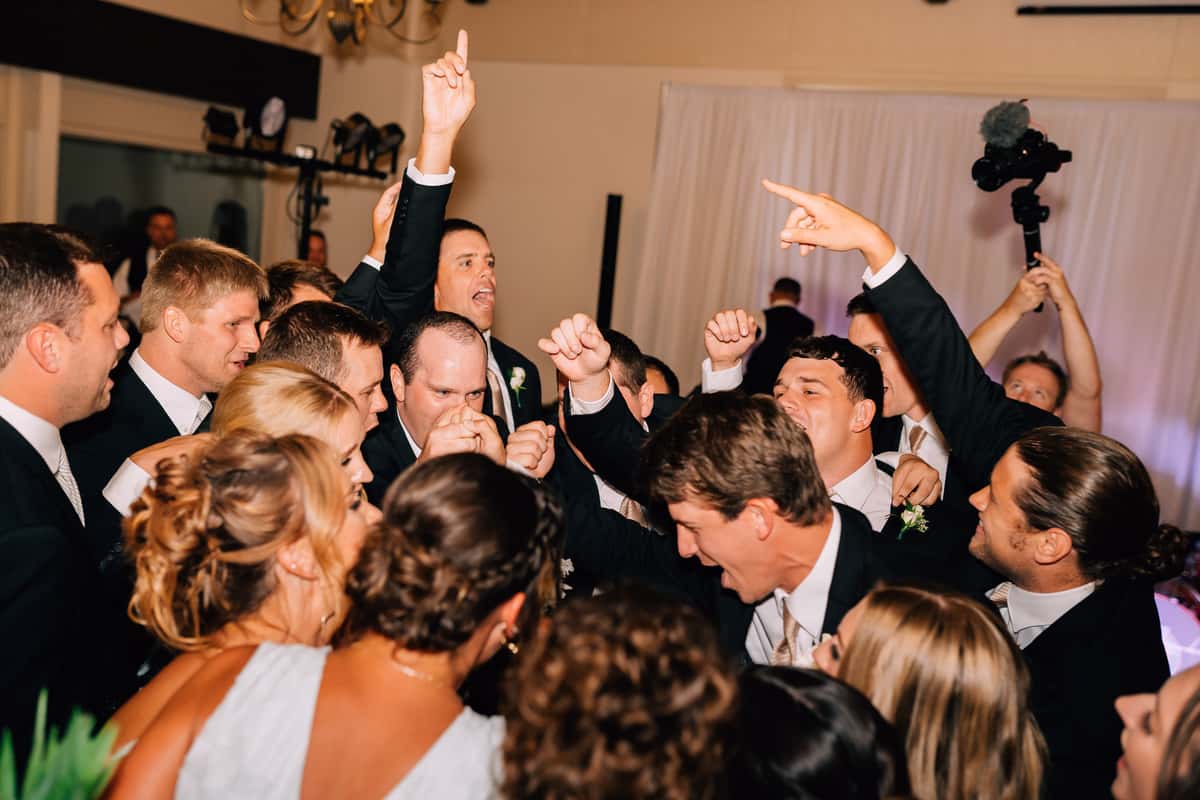 A wedding party dances