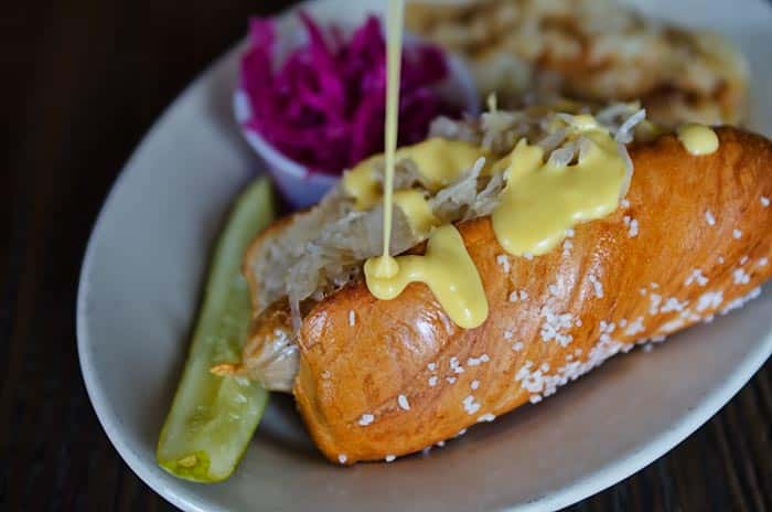 Photo of cheese dripping onto a sausage sandwich