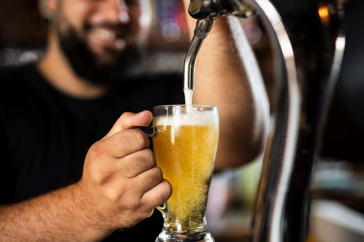 bartender pouring beer from tap