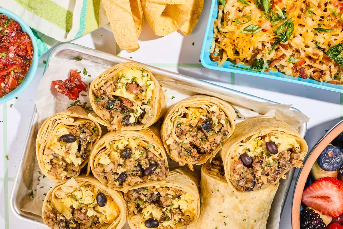 Snooze breakfast burritos with scrambled eggs, sausage and potatoes in a catering tray for office and group orders