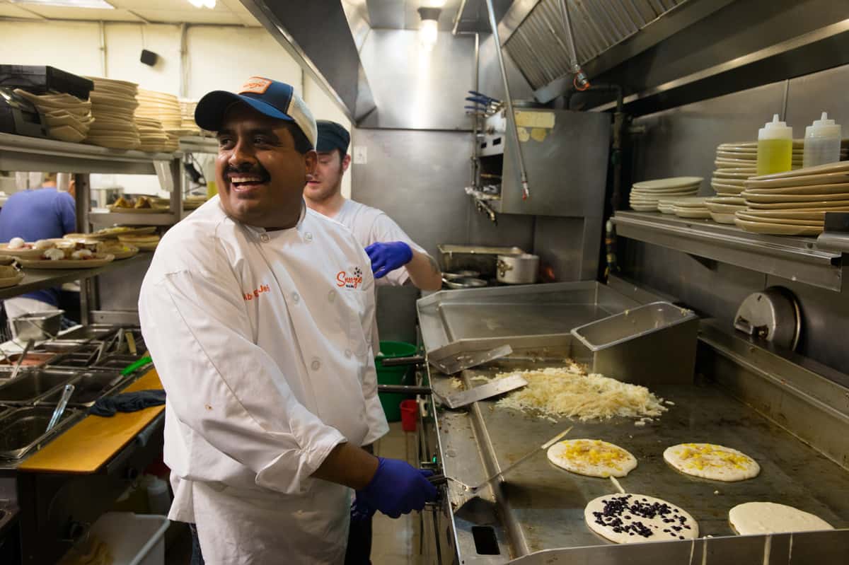 Snooze chefs in the kitchen smiling because they love their job