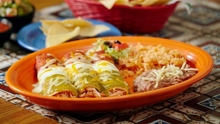 Enchiladas 3 soft corn tortillas wrapped around meat and cheese and then covered in the sauce of your choosing and even more cheese