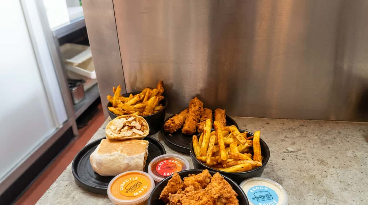 Chicken wrap served with crispy fries and dipping sauce