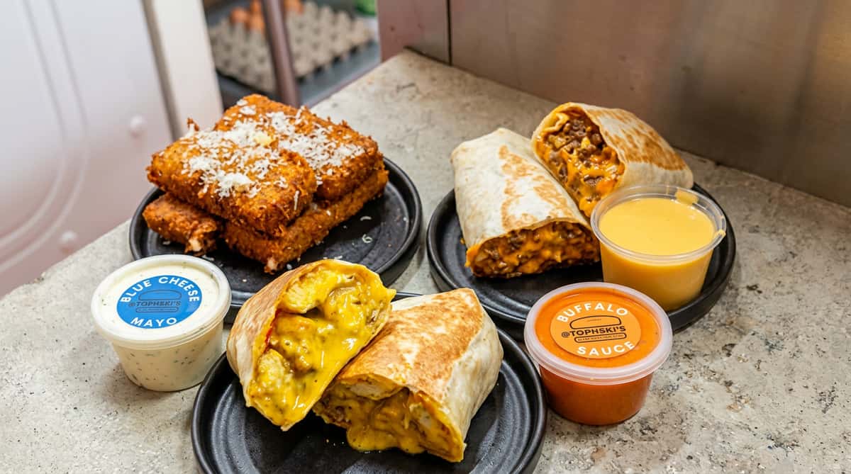 Cheesy burritos served with crispy fries and sauces