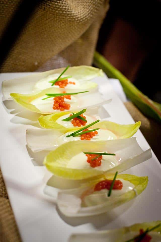 hor d'oeuvres platter of lettuce boats filled with a sauce and topped with caviar