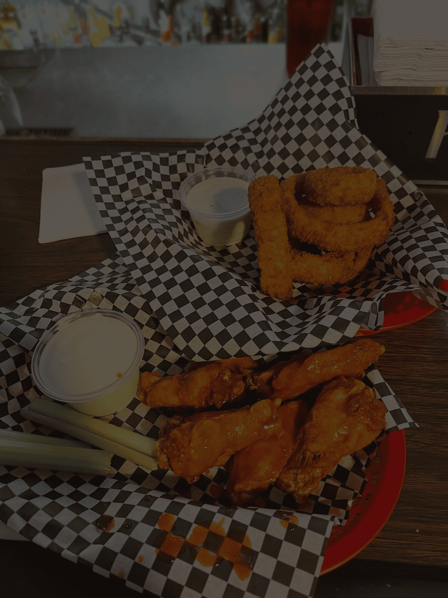 Fried chicken cutlets with a crispy, seasoned crust on checkerboard paper.