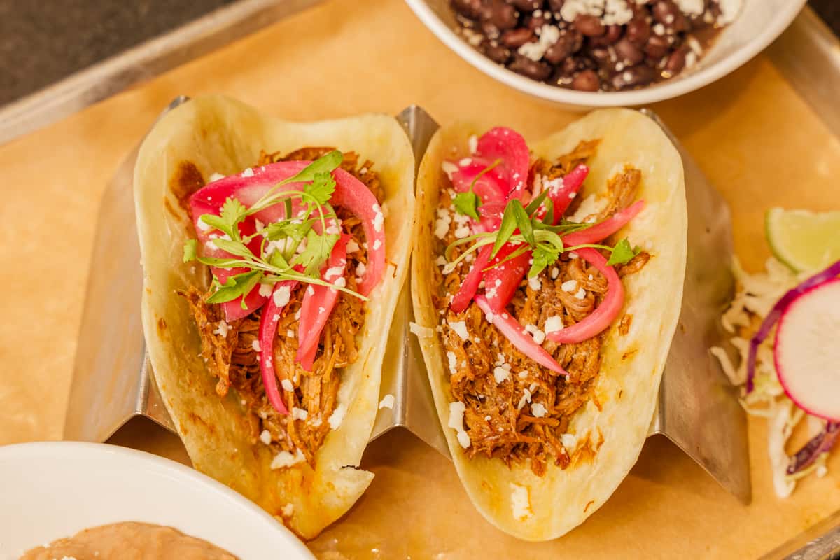 Chicken Tinga Tacos. Try them by the dozen!