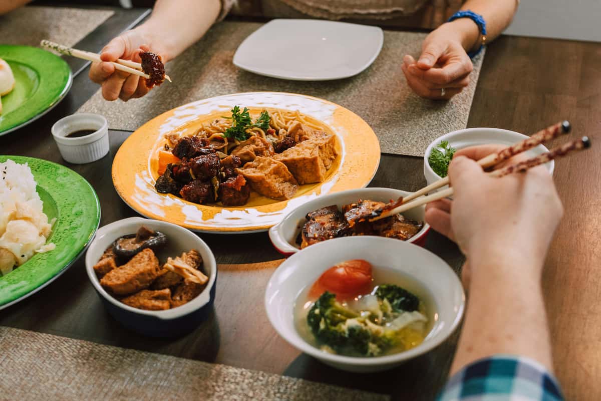 A group of people eating Thai food the traditional way