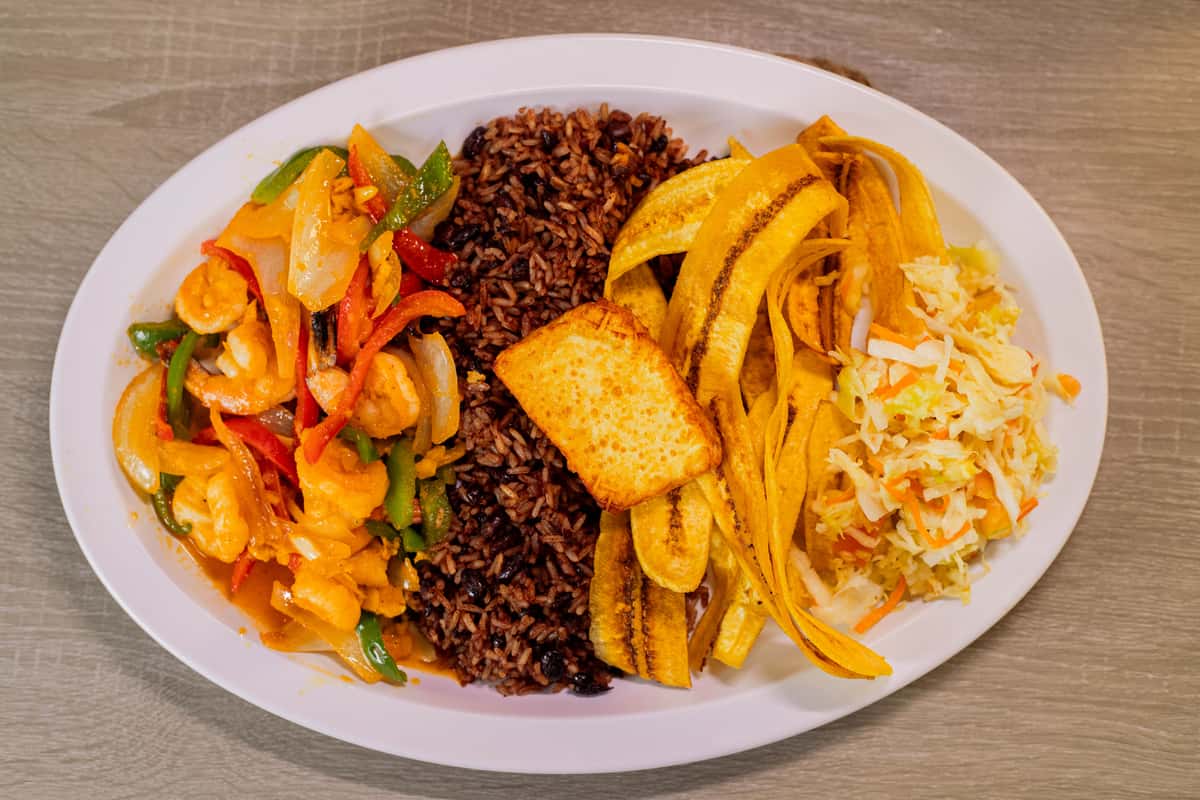 shrimps with Garlic, served with Gallo pinto, Handmade Plantain chips or sweet soft plantain, fried cheese and cabbage salad