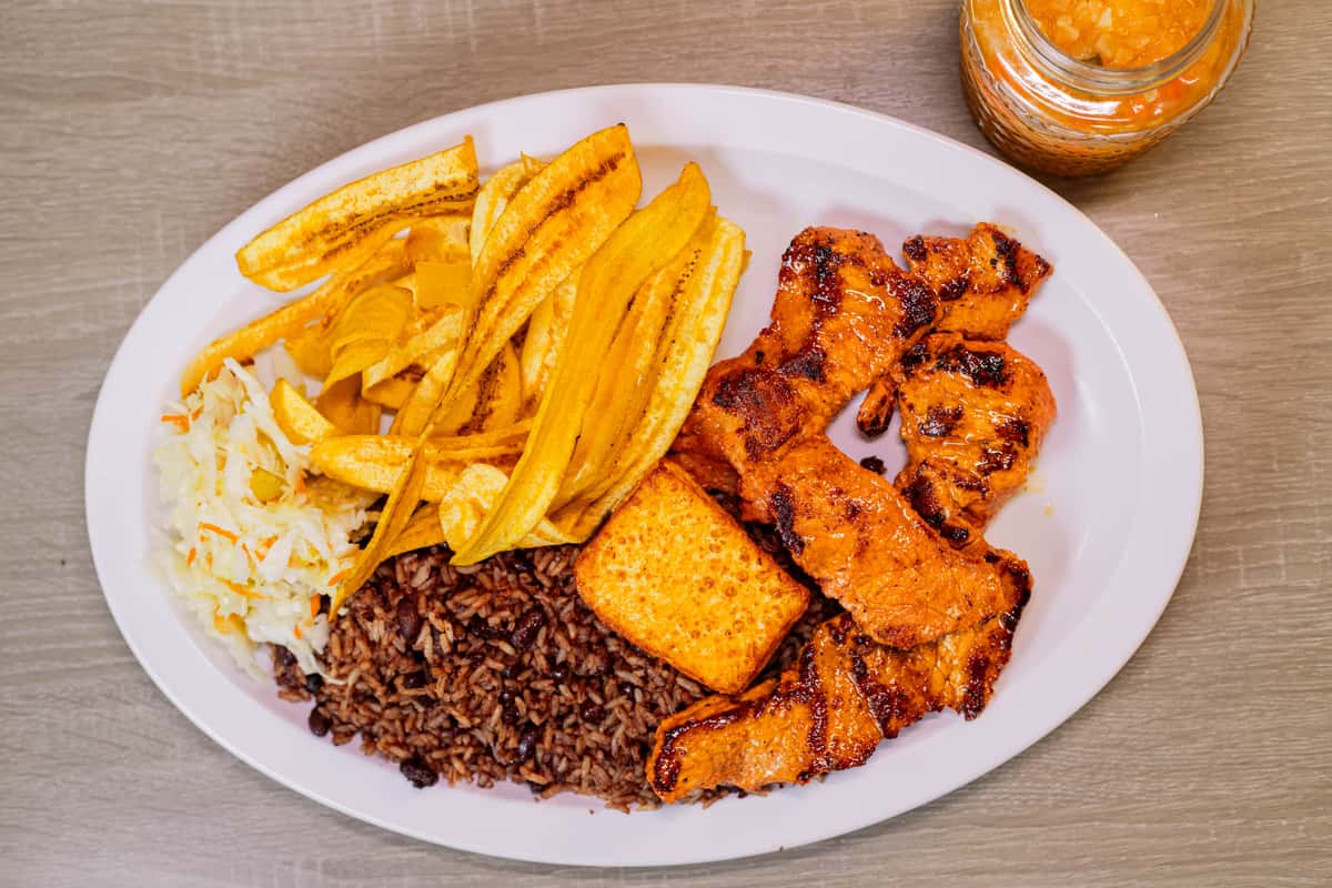 served with Gallo pinto, Handmade Plantain chips or sweet soft plantain, fried cheese and cabbage salad