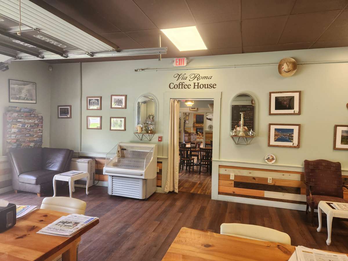 Coffee Shop : Indoor View: Wooden Floor, White Wallpaper, Picture Frames on the wall