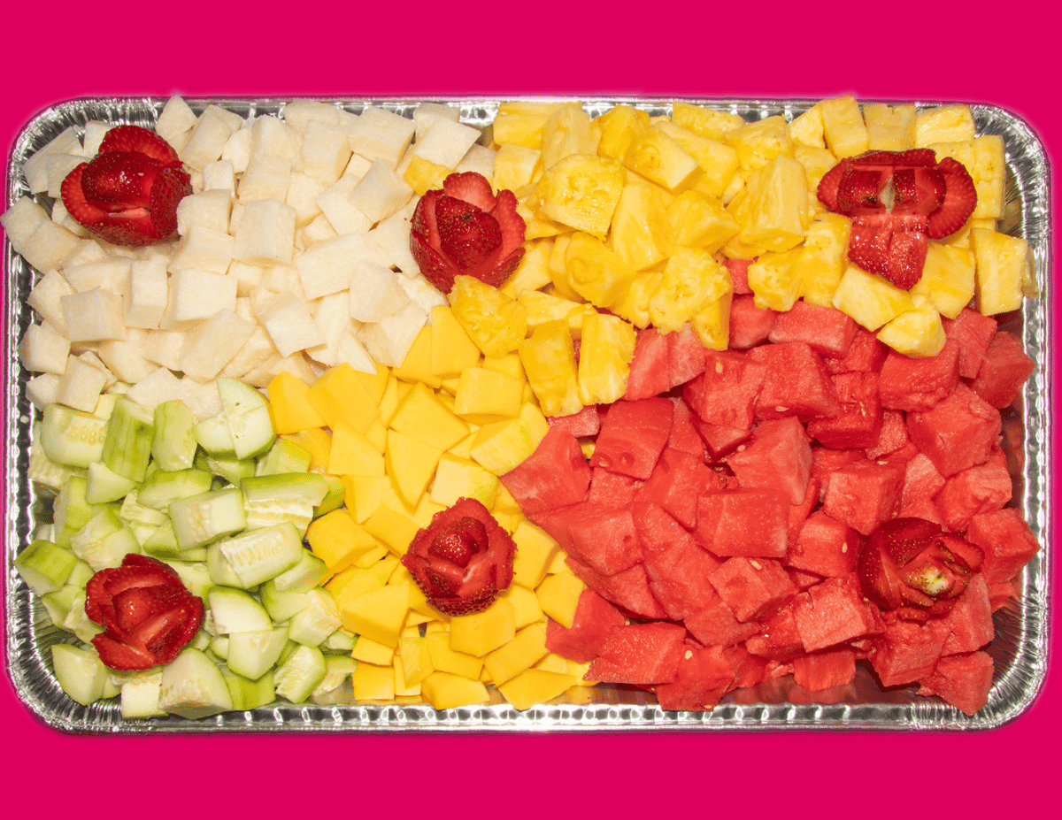 party tray filled with pineapple, mango, cucumber, watermelon, and jicama