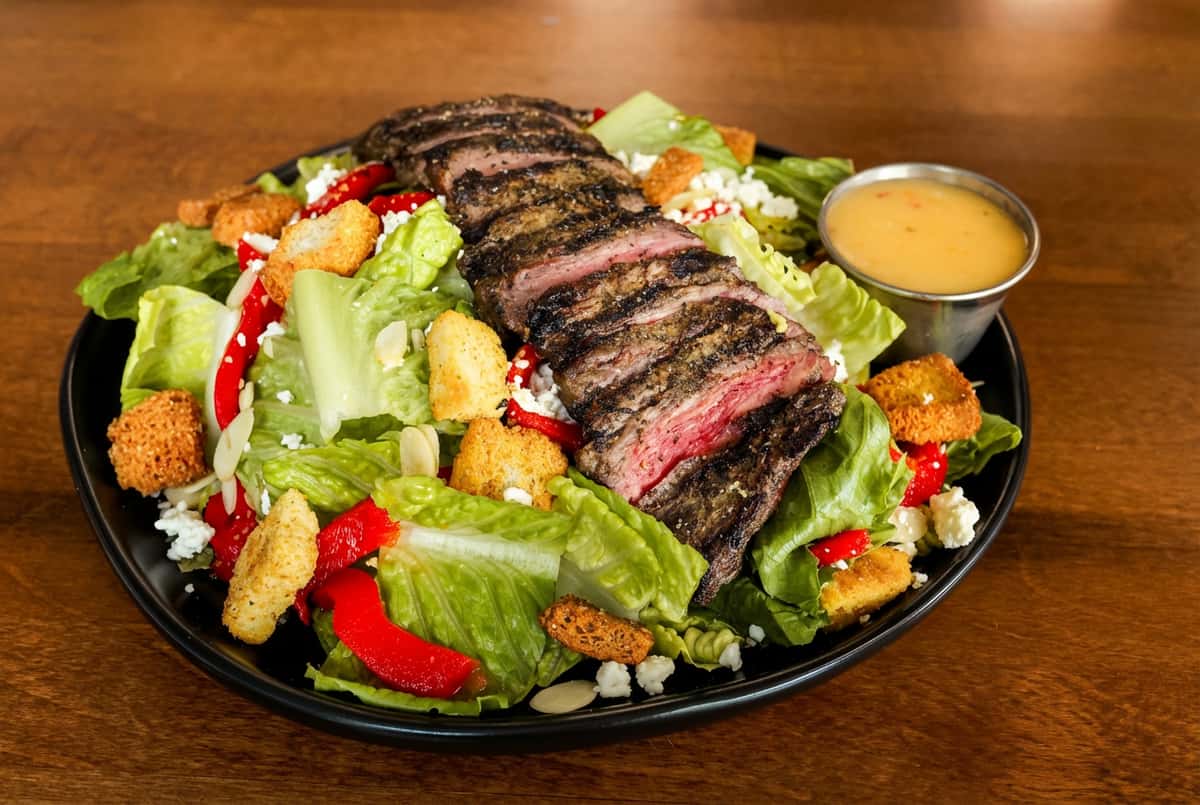 Meat slices on a plate of salad