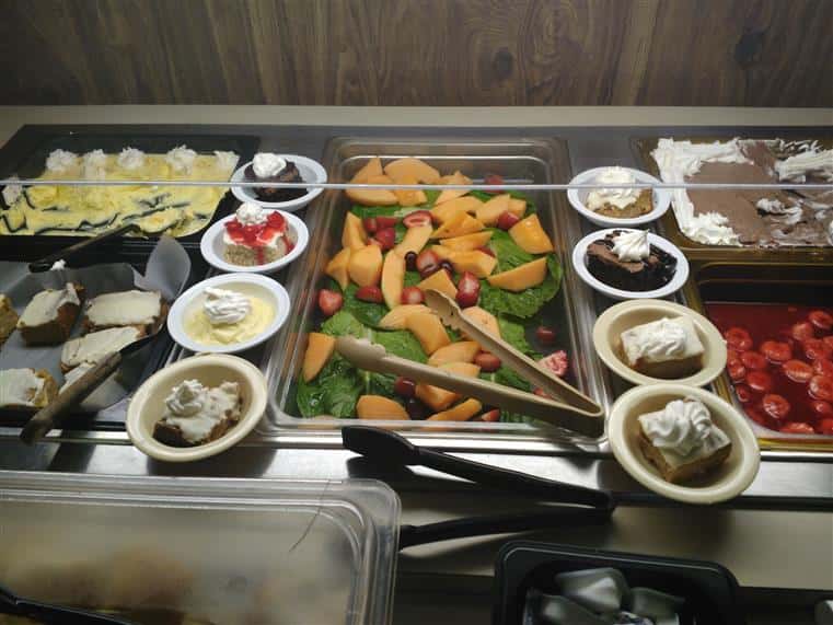 dessert and trays of food on buffet