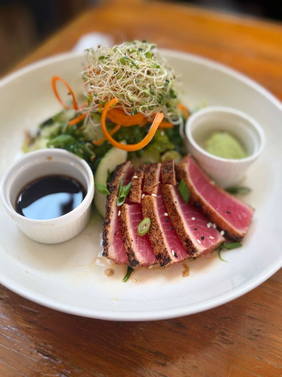 seared ahi tuna, greens, seaweed salad, spiraled carrots, celery, red onions, wasabi-ponzu-cucumber dressing