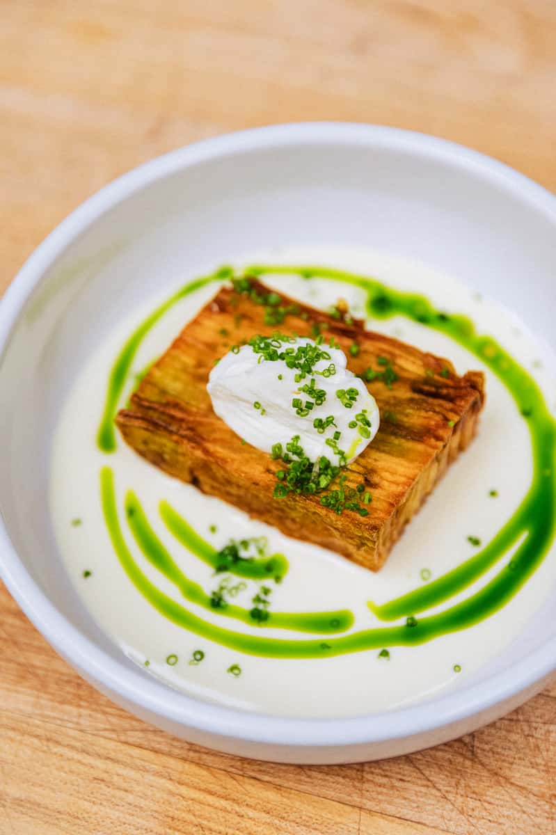 Plate of food with a green drizzle