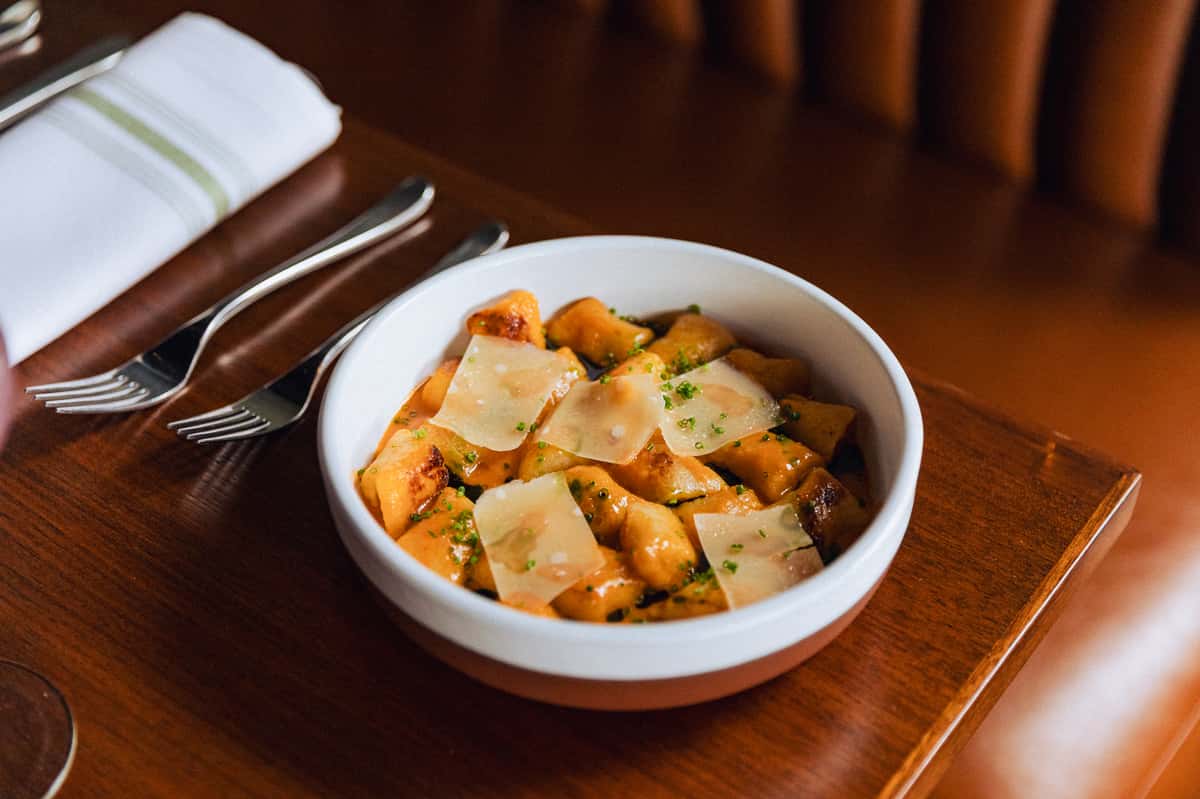 Bowl of gnocchi with sliced cheese