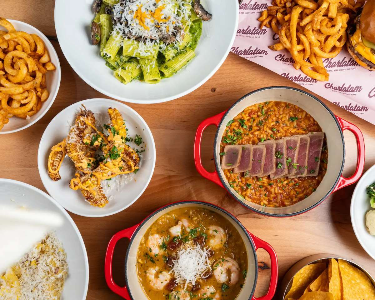 Chef-curated spread featuring pasta, baked dishes, appetizers, and fries, arranged for family-style dining.