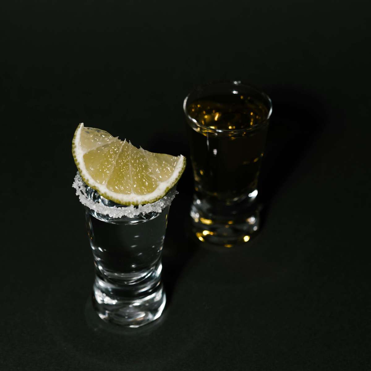 Old Shawnee Pizza's two tequila shots, one with a lime wedge and salt.