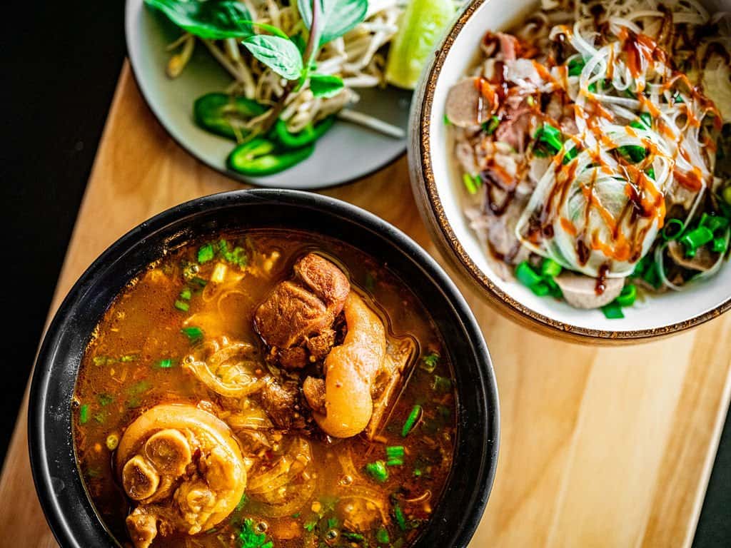 Multiple plates of Vietnamese food